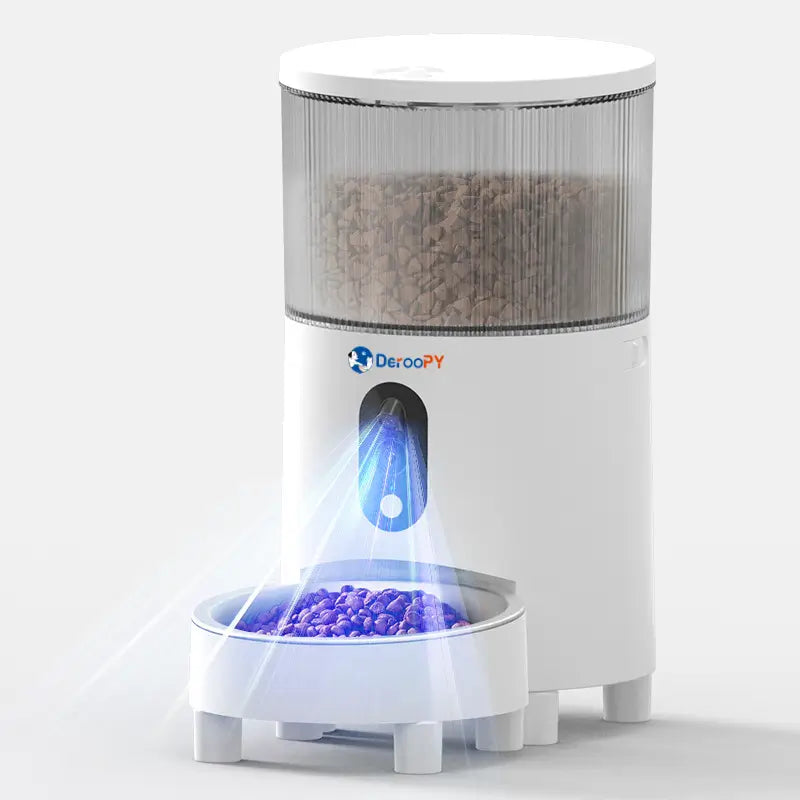 Automatic pet feeder dispensing dry food into stainless steel bowl with LED light.